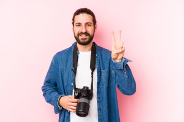 Young caucasian photographer man isolated showing number two with fingers.