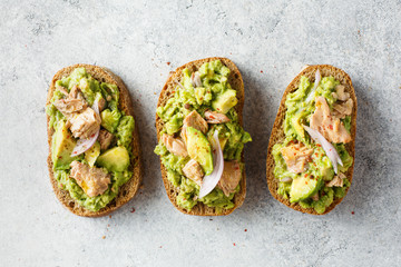 Healthy toast with avocado and tuna. - obrazy, fototapety, plakaty