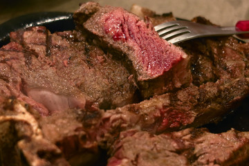 closeup medium rare beef steak in hot plate