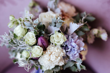 Rich bunch of pink peonies and lilac eustoma roses flowers, green leaf in glass vase. Fresh spring bouquet. Summer Background