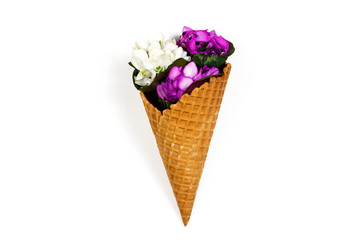 Ice cream waffle cone with spring flower wildflowers bouquet on white background. Spring and summer holiday minimal flat lay concept. Part of set.