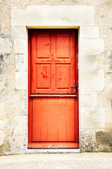 Weathered rustic woden front door of a stone built house in South Western France