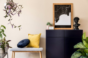 Interior design of sitting room with stylish wooden bench, gold clock, plants, commode and elegant personal accessoreis. Brown wooden mock up poster map on the beige wall. Home decor. Template.