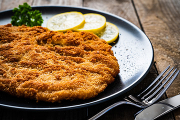 Schnitzel with  lemon on timber background