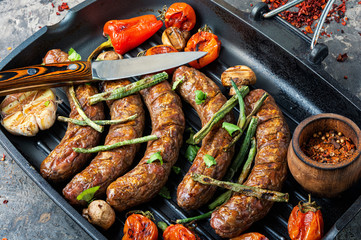 Grilled sausages in frying pan