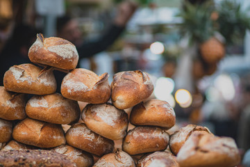 A pile of fresh bread made from whole flour. Crispy, blurred background. The Market, Jerusalem.