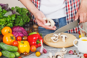 Woman cooks at the kitchen, body part, blurred background