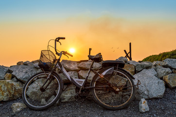 old rusty bike with beautiful sun at background