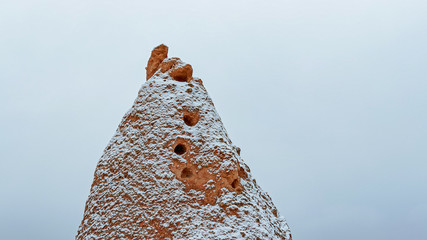 Fairy chimneys with snowy landscape at Devrent Valley in Cappadocia. Unique rock formations in Imaginary Valley in winter season in Cappadocia.