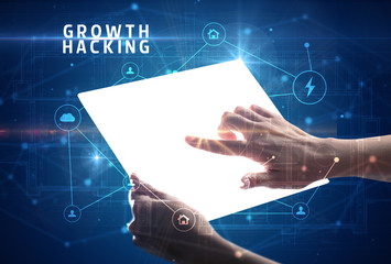 Holding futuristic tablet with GROWTH HACKING inscription, cyber security concept