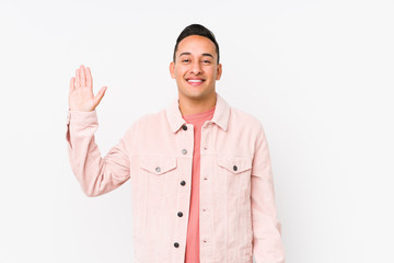 Young latin man posing isolated smiling cheerful showing number five with fingers.