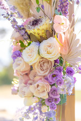 Decorative decoration of the wedding arch with fresh flowers. Holding a wedding ceremony in the open. Decoration details