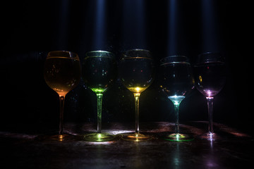 Goblet of white wine on wooden table on wooden wall background