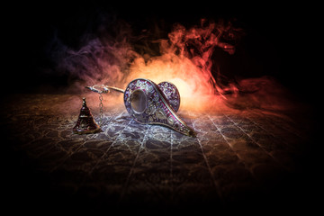 Lamp of wishes concept. Antique Aladdin arabian nights genie style oil lamp with soft light white...