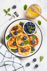 Cottage cheese pancakes on white.