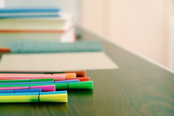Back to school background with books, pencils colorful on wooden table classroom.
