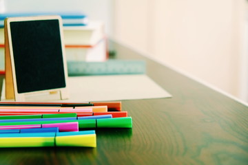Back to school background with books, pencils colorful  on wooden table classroom.