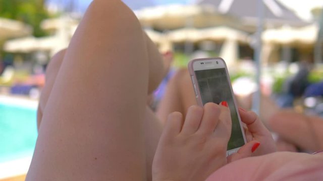 Woman using phone on the vacations in 4k slow motion 60fps