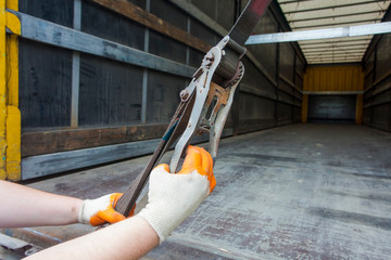 hands holding strap belt for truck cargo transportation