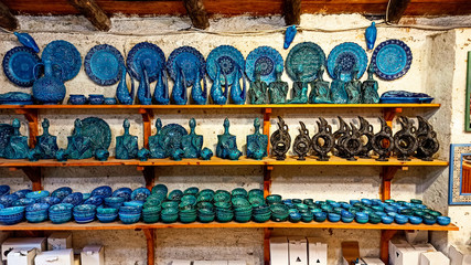 Hittite wine vessels, colorful ceramic vases and porcelain bowls in a underground cave atelier in Avanos in Cappadocia. Turkish traditional ceramic handycrafts in a local pottery shop in Cappadocia