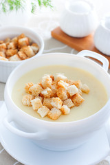 Mashed potato soup with croutons of white bread, selective focus