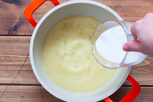 Step-by-step Preparation Of Mashed Potato Soup With Homemade Croutons, Step 7 - Adding Cream To The Soup, Top View, Horizontal