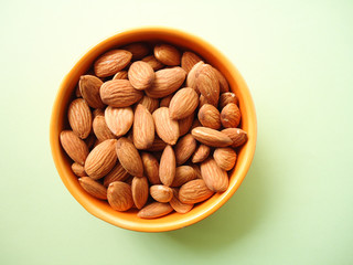 fresh almonds in a bowl, top view