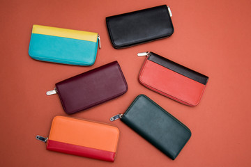 design leather female clutches isolated on orange background