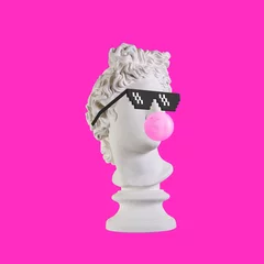 Fotobehang Statue on a pink background. Gypsum statue of Apollo head. Man. Creative. Plaster statue of Apollo head in pixel glasses. Minimal concept art. © stasnds