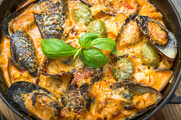 mussels with cheese sauce, in a frying pan