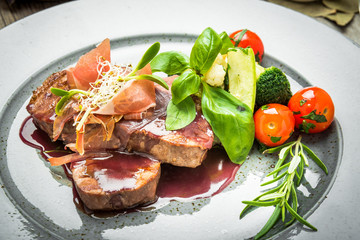 Medallions of veal, with sauce on a plate.