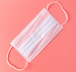 Medical mask isolated on a pink