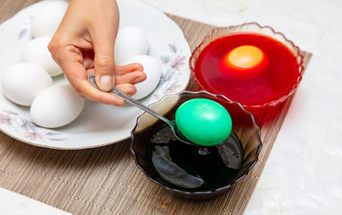 Painting eggs in the kitchen.