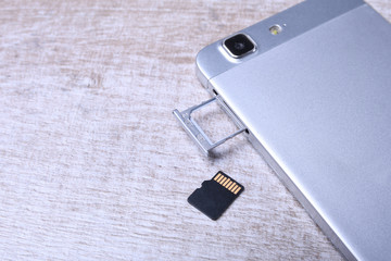 Flash memory data storage concept : A tray with a micro SD card on white background. A memory card...