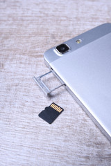 Flash memory data storage concept : A tray with a micro SD card on white background. A memory card...