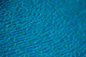 A backgroung view of blue water in the pool outdoor