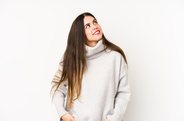 Young caucasian woman isolated on a white background dreaming of achieving goals and purposes