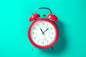 Alarm clock on the color background.