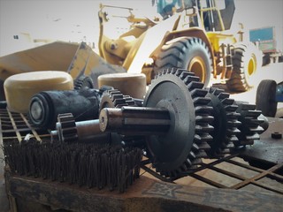 Metal spur gear of wheel loader in machine reparing workshop, maintenance concept, consctruction...