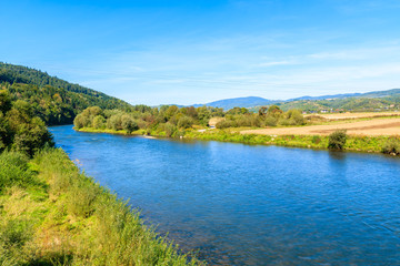 Fototapeta na wymiar View of river near Velo Dunajec cycling road, Beskid Sadecki Mountains, Poland