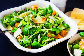 Salad with green leaf, tangerine and parmesan.