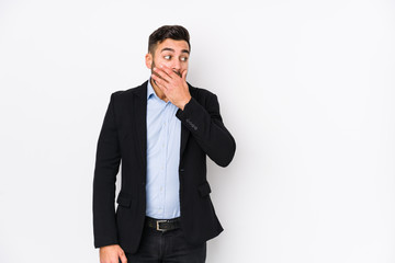 Young caucasian business man against a white background isolated thoughtful looking to a copy space covering mouth with hand.