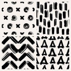Set of 4 abstract vector seamless patterns with various shapes made with brush strokes. Hand-drawn grunge ink wallpapers. Creative repeating backgrounds.