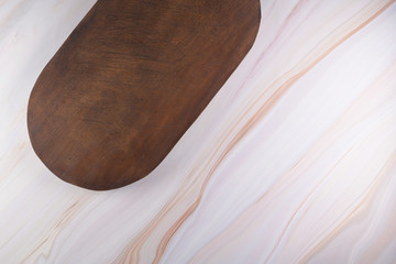 Wooden cutting board on a gray marble background