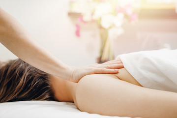 Obraz na płótnie Canvas Young beautiful woman having professional shoulders massage in spa salon