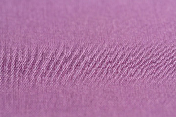 Close-up of violet texture fabric cloth texture background. Selective focus in center