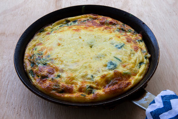 Frittata made of eggs, bacon, cheese and spinach