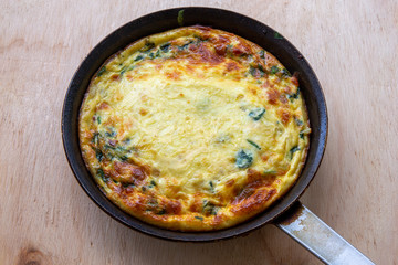 Frittata made of eggs, bacon, cheese and spinach