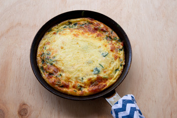 Frittata made of eggs, bacon, cheese and spinach