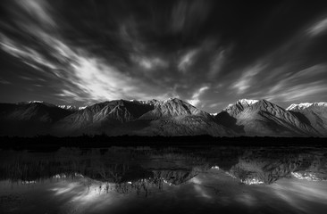 Serene view of Himalayan mountain range reflection in black and white